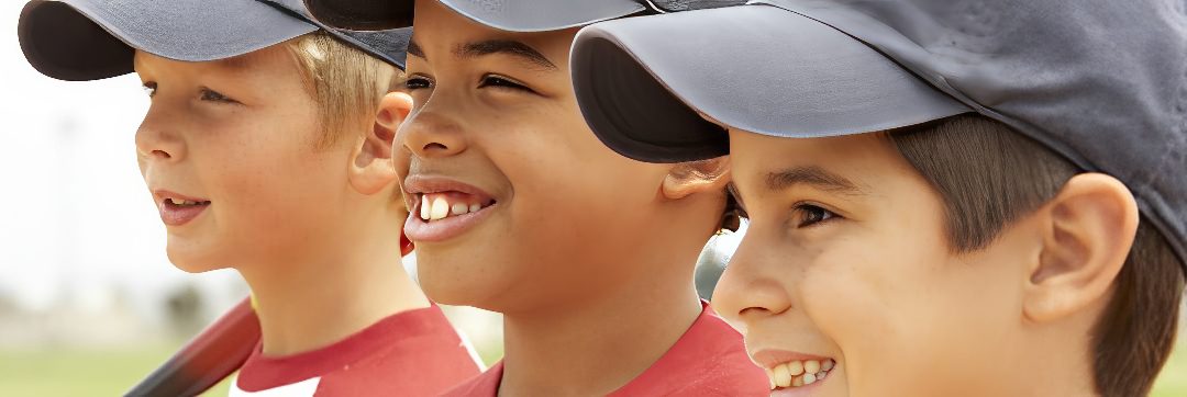 Happy kids wearing baseball uniforms