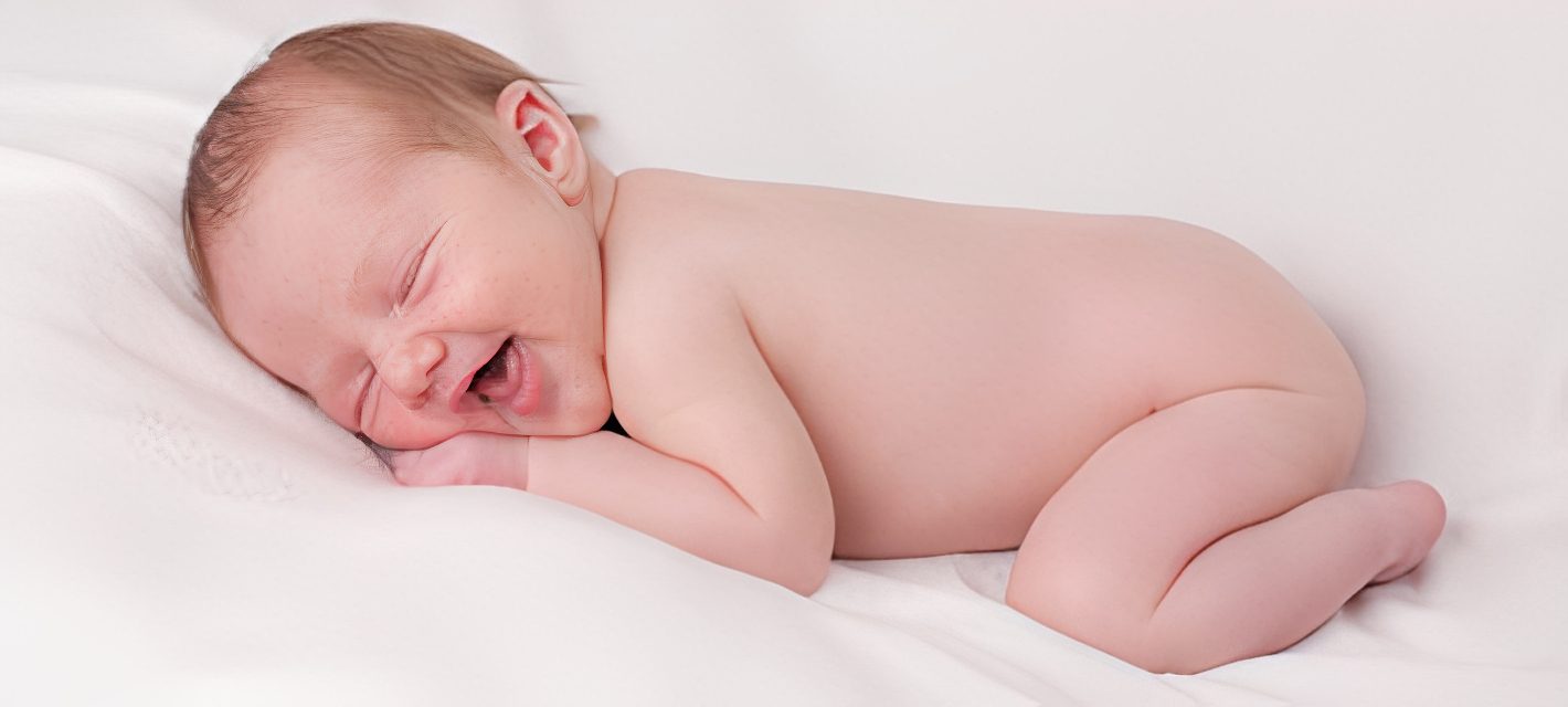 Newborn baby on white blanket