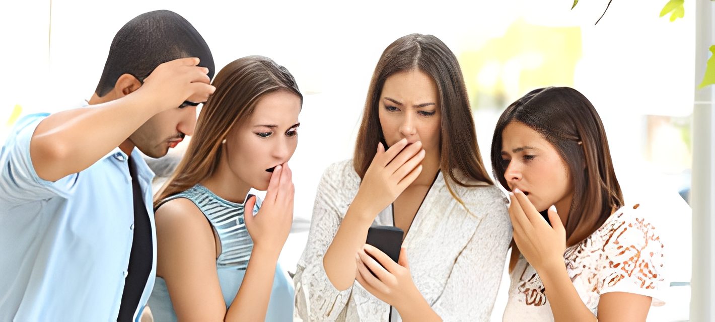 Four people reacting to phone screen