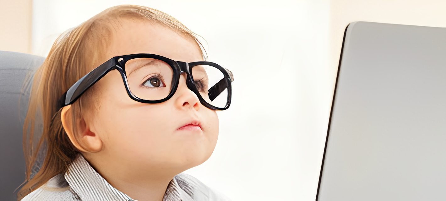 Child focused on laptop display