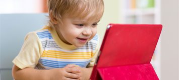 Toddler watching screen excitedly