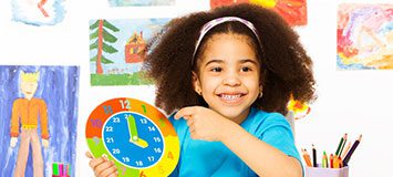 Smiling girl with art projects behind