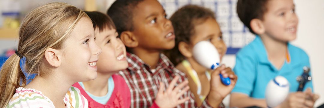 Children playing musical instruments in class